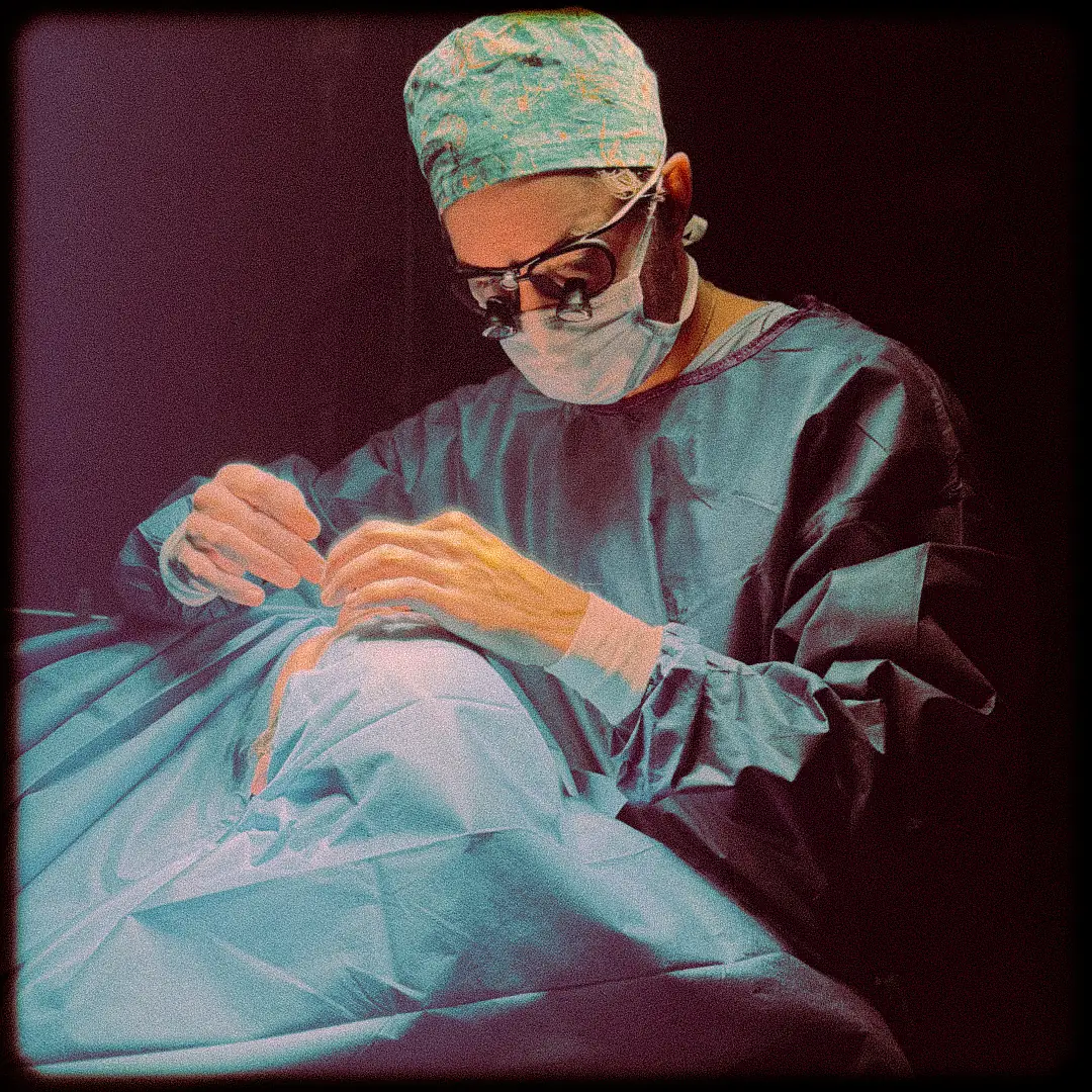 Dr Thomas Colson performing surgery with surgical loupes in the operating room at Sheikh Khalifa Medical City, Abu Dhabi